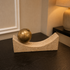 Curved Travertine With Brass Sphere